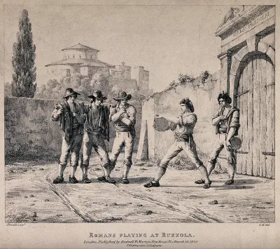 Young men playing a outdoor bowling game with round discs