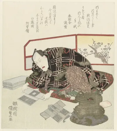 Man Folds Miniature Kimonos