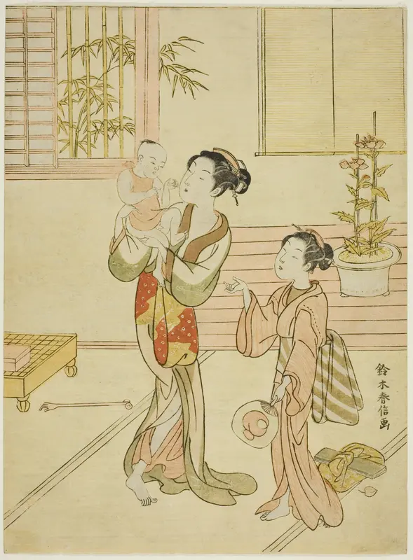 A woman and girl amusing a baby