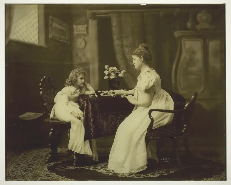 Woman and Child Playing Dominoes at Table Wall Art by Unknown - High-Resolution Digital Print
