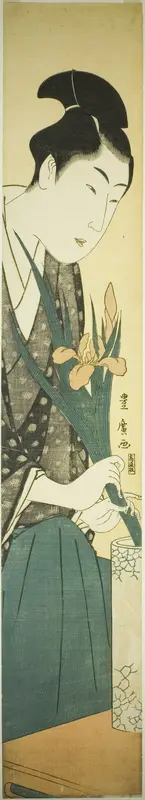 Young man arranging irises in a vase