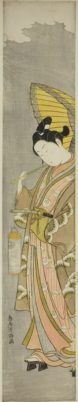 Young man holding umbrella and lantern